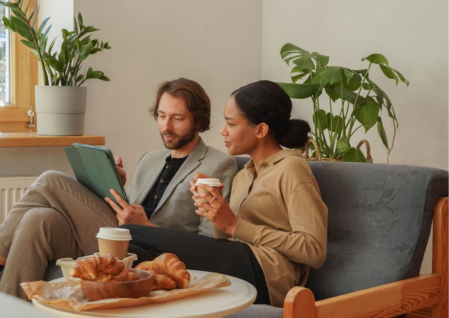 Two customers paying for coffee with a phone